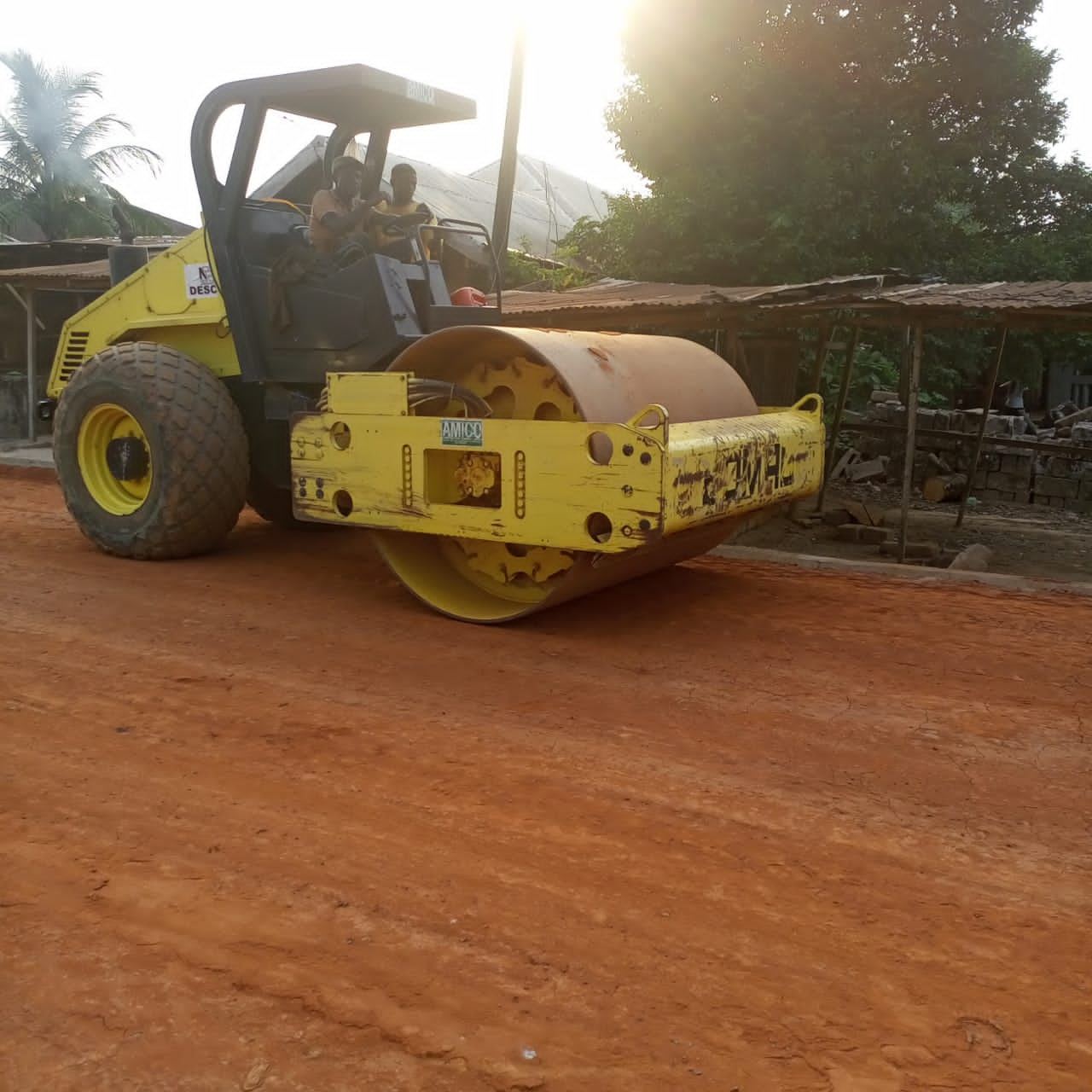 Road roller compacting a laterite road base